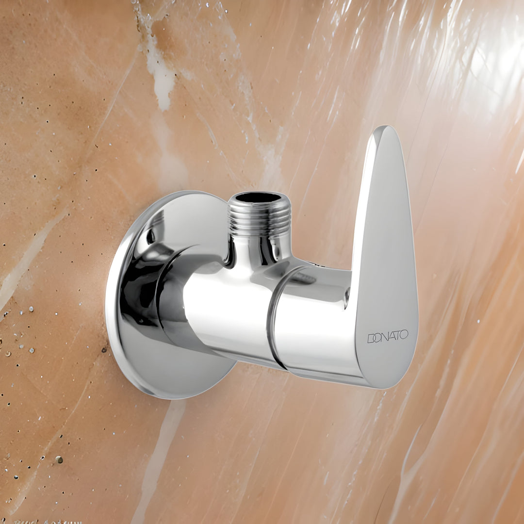 Brass angle valve with a polished finish, installed under a kitchen sink for water control