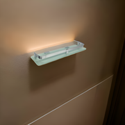 Stylish glass corner shelf displaying books and decorative items